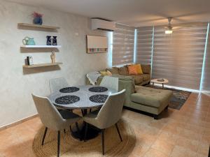 a living room with a table and a couch at NaboBlue Ocean View Apartment Maunabo PR in Maunabo
