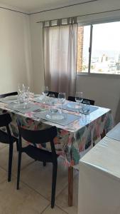 a dining room table with wine glasses on it at Departamento Céntrico Equipado in San Fernando del Valle de Catamarca