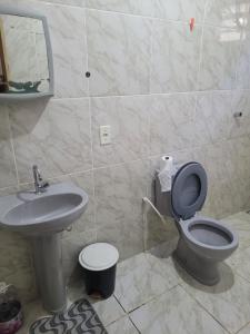 a bathroom with a toilet and a sink at Casa Correntina BA 3 quartos in Correntina