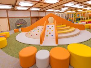 a childrens play room with an indoor slide at Ooedo Onsen Monogatari Premium Hotel Sokan in Matsushima
