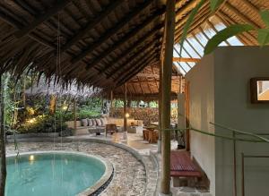 an outdoor swimming pool in a villa with a patio at Dalakit House Hidden Garden Oasis in Lambojon
