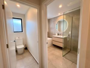 a bathroom with a shower and a toilet and a sink at Style, Space and Comfort in Twizel +4 photos