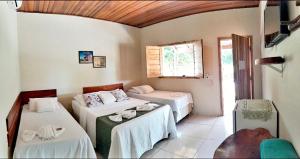 a bedroom with two beds and a window at Pousada do Nondas in Estivado +35 photos