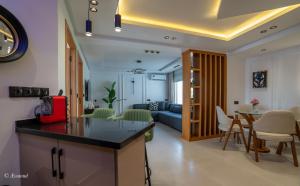 a kitchen and living room with a couch and a table at RamoHouse bright home central in Chefchaouen