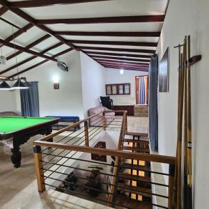 a room with a ping pong table and a living room at Ellakanda Nature Villa in Uragoda