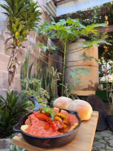 a bowl of food on a table with bread at Los Portones de Ataco in Concepción de Ataco