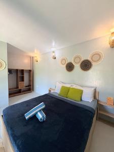 a bedroom with a large bed with a scale on it at Jaydy Guest House in General Luna