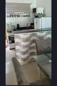 a kitchen with a counter with plates on it at LardoceLar in Camaçari