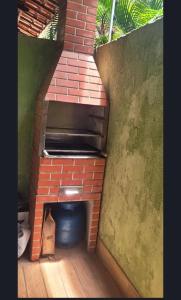 a brick oven in a room with a brick wall at LardoceLar in Camaçari