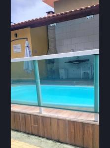 a swimming pool with a view of the outside at LardoceLar in Camaçari