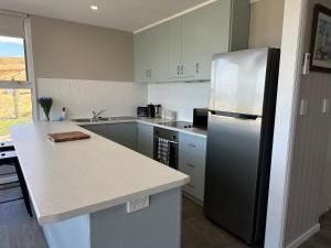 a kitchen with a refrigerator and a counter top at Beachscape in Stanley