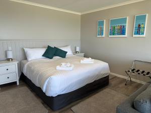 a bedroom with a bed with two towels on it at Beachscape in Stanley