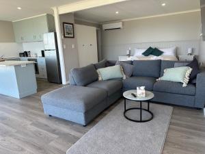 a living room with a couch and a table at Beachscape in Stanley
