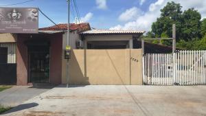 a building with a gate and a fence at Suíte Morada das Mangueiras Térreo in Soure +11 photos