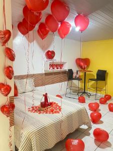 a room with red balloons hanging from the ceiling at Bru&Mar Pousada in Parnaíba