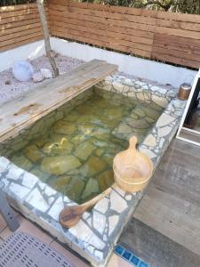 a swimming pool with a bowl and a wooden spoon at saunalu in Kido