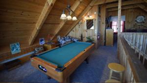 a room with a pool table in a cabin at Dreamcatcher Hideaway in Pigeon Forge