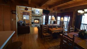a living room with a dining table and a fireplace at Dreamcatcher Hideaway in Pigeon Forge