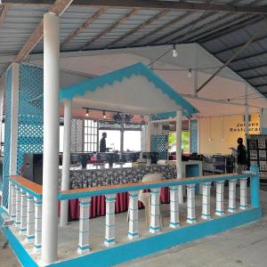 a building with a table and a bar in it at Johans Chalet & Restaurant in Tioman Island