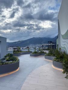 a courtyard on a building with a view of a city at Adagio Quito Suite de Lujo in Quito
