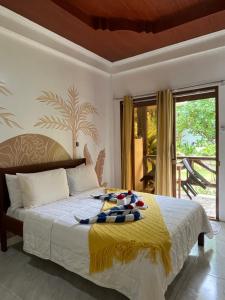 a bedroom with a bed with a towel on it at Villa Consolacion Resort in General Luna
