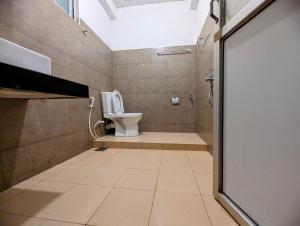a bathroom with a toilet and a shower at Relax Apartment Toppass in Nuwara Eliya +12 photos