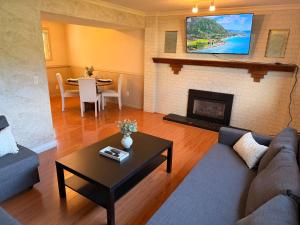 a living room with a couch and a fireplace at Spacious 2 Bedroom Suite in Delta