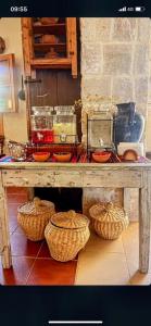 a wooden table with baskets on top of it at Beit Al Rahi in Ḑahr al Ḩarf