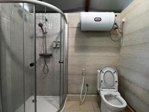 a small bathroom with a shower and a toilet at Canopy Villa Sireh Park in Johor Bahru +13 photos