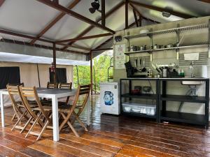 a kitchen with a table and chairs in a tent at Canopy Villa Sireh Park in Johor Bahru