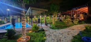 a resort with a swimming pool at night at Palisade Garden in Ấp Thiện Sơn