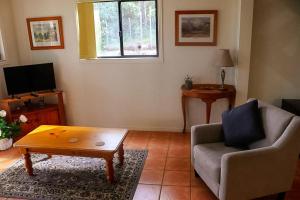 a living room with a couch and a coffee table at LAKE VIEW CHALET Australia Zoo close by in Landsborough +30 photos