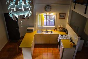a kitchen with a sink and a clock on the wall at LAKE VIEW CHALET Australia Zoo close by in Landsborough