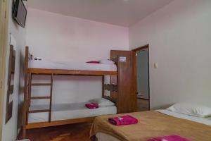 a room with two bunk beds and a ladder at Pousada ExpoBH in Belo Horizonte