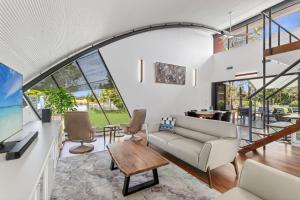 a living room with a couch and a table at Sunsets on Kalang in Urunga