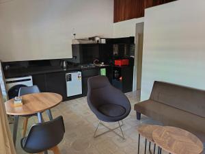 a kitchen with a couch and a chair and a table at LG Palms in Sigatoka