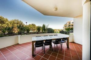a table and chairs on a balcony with a view at The Breakers Yamba in Yamba