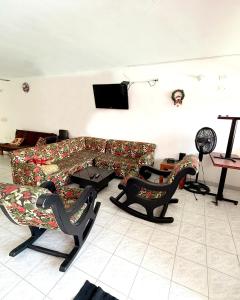a living room with two couches and a television at Casa con piscina privada Girardot in Girardot