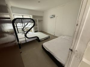 a hospital room with two beds and a window at Casa con piscina privada Girardot in Girardot +21 photos