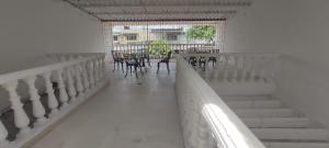 a staircase with tables and chairs in a building at Casa con piscina privada Girardot in Girardot