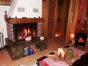 a living room with a fireplace and a table at Alp Chnorz Penthouse in Nesslau +100 photos