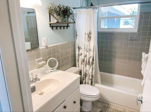 a bathroom with a sink and a toilet and a mirror at Lemon Bay Hideaway, Retro Beach Bungalow in Venice +30 photos