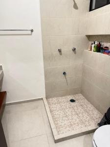 a bathroom with a shower with a glass door at Casa completa , dos Habitaciones con baño en cada cuarto in Mérida