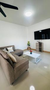 a living room with a couch and a coffee table at Kitjamyhome2 in Ban Tha Thon
