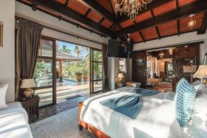 a bedroom with a bed and a large window at Arun Rapee Villa Surin Beach in Surin Beach +95 photos