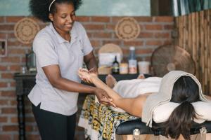 a woman is giving a woman a massage at Thornicroft Lodge - South Luangwa in Mfuwe