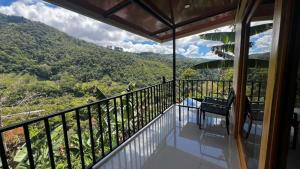 a balcony with a view of a mountain at Chirripó Oasis in Canaán +19 photos