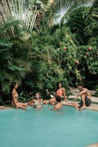 a group of people sitting in a swimming pool at Tropical Temple Siargao Resort in General Luna