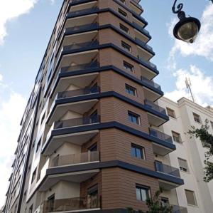 a tall building with balconies on the side of it at Sirena Apartment Tangier in Tangier