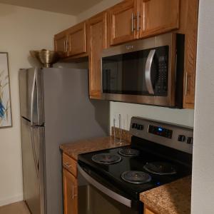 a kitchen with a stove and a microwave at Elegant 2Bed & 2 Bath Comfort in Dallas